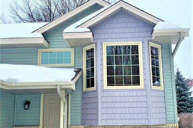 Inspiration for a large multicolored split-level mixed siding house exterior remodel in Minneapolis with a shingle roof