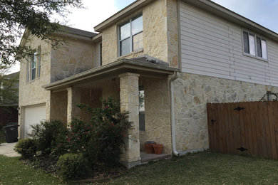 Mid-sized elegant beige two-story stone exterior home photo in Austin