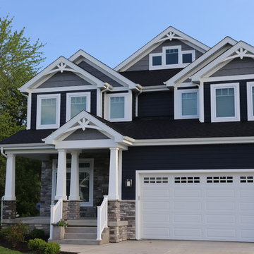Deep navy house white trim Custom home with front porch