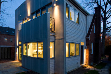 Idée de décoration pour une façade de maison grise minimaliste à un étage avec un revêtement mixte et un toit plat.