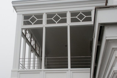Imagen de fachada de casa beige costera grande de tres plantas con revestimiento de madera, tejado a cuatro aguas y tejado de teja de madera