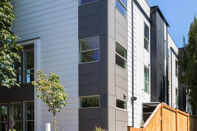 Large minimalist multicolored three-story mixed siding exterior home photo in Seattle