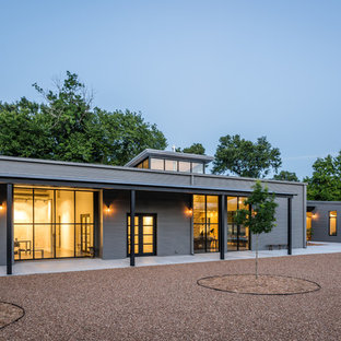 Large industrial gray one-story metal gable roof idea in Houston