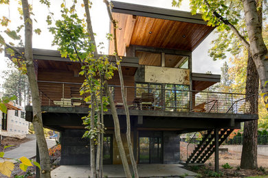 Example of a large minimalist two-story mixed siding flat roof design in Seattle