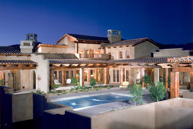 Design ideas for a mediterranean house exterior in Phoenix.