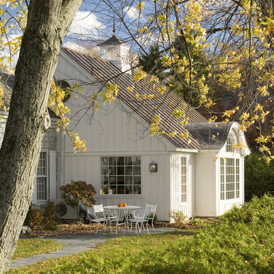 Example of a mountain style white wood exterior home design in Burlington