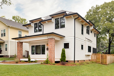 Mid-sized arts and crafts white two-story concrete fiberboard house exterior photo in Charlotte with a hip roof and a shingle roof