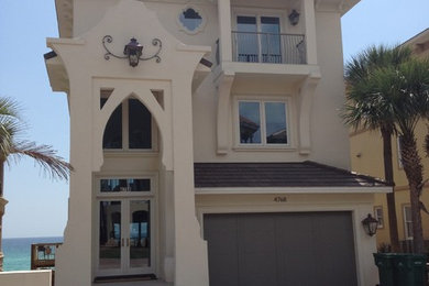 Coastal white three-story stucco exterior home idea in Tampa