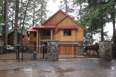 Example of a large mountain style two-story wood gable roof design in Portland