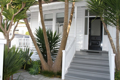 Design ideas for a large and white victorian bungalow house exterior in Auckland with wood cladding and a pitched roof.