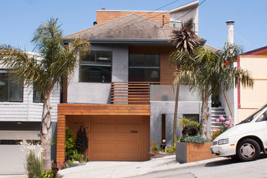 Example of a mid-sized trendy gray three-story concrete fiberboard exterior home design in San Francisco with a hip roof
