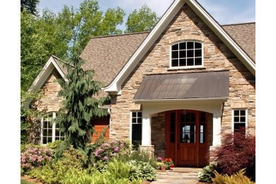Large craftsman two-story stone exterior home idea in Other with a shingle roof