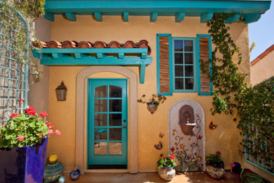 フェニックスにある中くらいなサンタフェスタイルのおしゃれな家の外観 (アドベサイディング) の写真