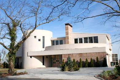 Large and beige modern two floor render house exterior in New York with a half-hip roof.