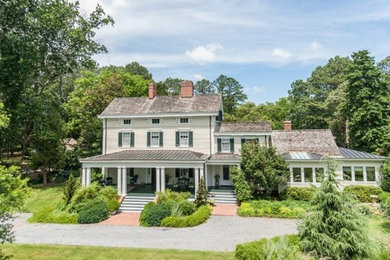 Mid-sized elegant beige three-story wood exterior home photo in Other with a shingle roof