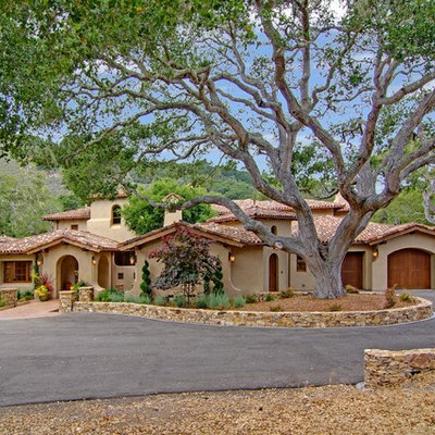 Large tuscan beige two-story stone gable roof photo in San Francisco with a tile roof