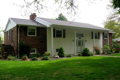 Example of a white two-story brick exterior home design in Chicago