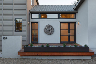 Inspiration for a mid-sized transitional gray two-story stucco exterior home remodel in San Francisco