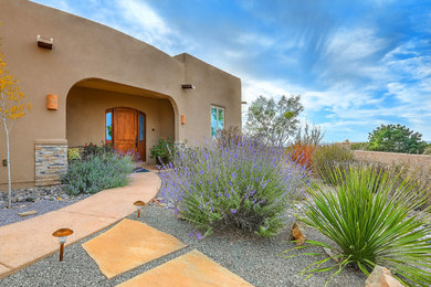 Mid-sized southwest beige one-story stucco exterior home photo in Albuquerque