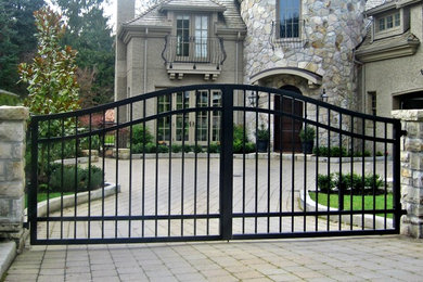 Example of a large arts and crafts beige two-story stone exterior home design in Vancouver