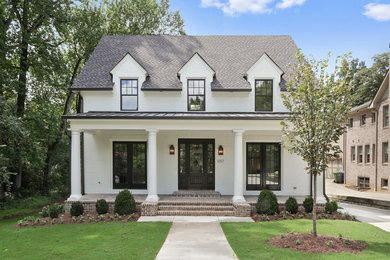 Large elegant white two-story brick exterior home photo in Atlanta with a shingle roof