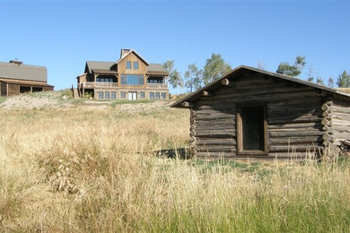 Example of a mid-sized mountain style brown two-story wood gable roof design in Boise