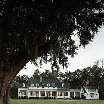 Example of a classic white two-story gable roof design in Atlanta