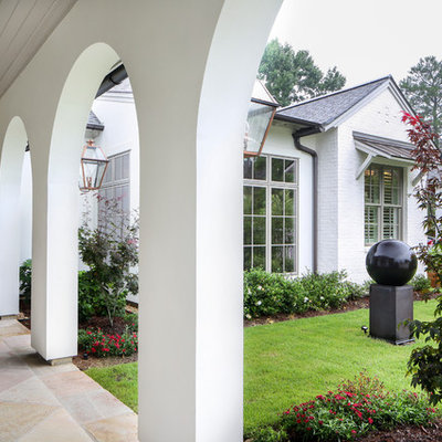 Large traditional white two-story mixed siding house exterior idea in New Orleans with a shingle roof
