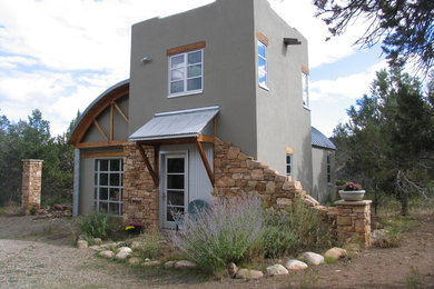 Example of an eclectic metal exterior home design in Denver