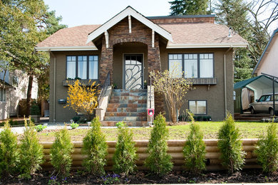 Mid-sized traditional brown three-story stucco exterior home idea in Vancouver with a hip roof