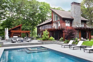 Inspiration for a large modern brown two-story wood exterior home remodel in New York with a shingle roof