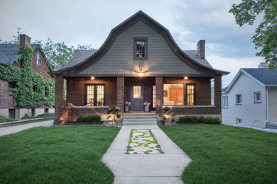 Inspiration for a traditional bungalow brick house exterior in Salt Lake City with a mansard roof.