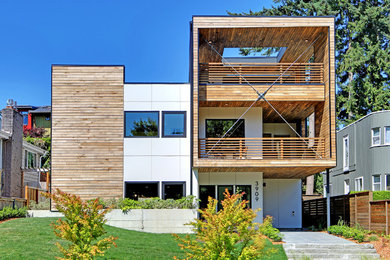 Diseño de fachada de casa blanca minimalista grande de tres plantas con revestimiento de madera y tejado plano