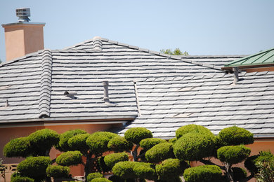 Photo of a large and beige classic bungalow house exterior in San Diego with a hip roof.