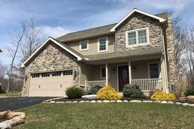 Example of a mid-sized classic beige two-story mixed siding exterior home design in Other with a shingle roof