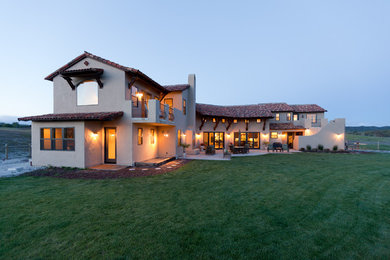 Inspiration for a mid-sized mediterranean beige two-story stucco exterior home remodel in San Luis Obispo with a tile roof