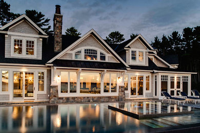 Inspiration for a large timeless white two-story mixed siding exterior home remodel in Other