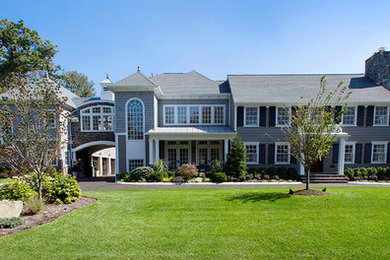 Large transitional blue two-story mixed siding exterior home idea in New York with a hip roof