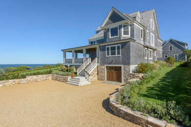 This is an example of a gey and medium sized beach style detached house in Boston with three floors, wood cladding, a pitched roof and a shingle roof.
