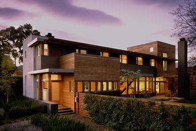 Large contemporary brown one-story wood flat roof idea in San Diego