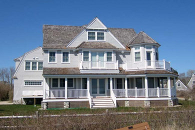 Inspiration for a large timeless gray three-story wood exterior home remodel in Boston with a shingle roof