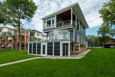 Beach style gray two-story house exterior photo in Other with a shed roof and a metal roof