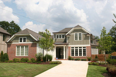 Example of a mid-sized classic green two-story mixed siding house exterior design in Atlanta with a clipped gable roof and a shingle roof