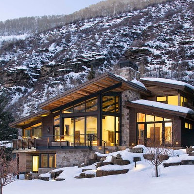Large rustic two-story mixed siding exterior home idea in Denver with a shed roof