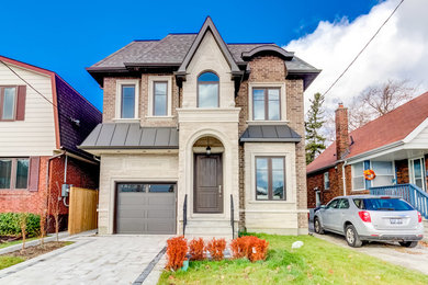 Traditional beige two-story brick house exterior idea in Toronto with a hip roof and a shingle roof