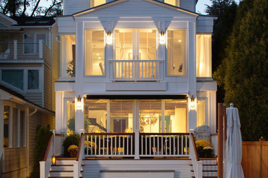Example of a beach style white three-story exterior home design in Baltimore