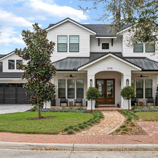 Transitional white two-story exterior home idea in Orlando with a mixed material roof