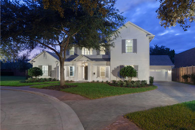 Inspiration for a large and white traditional two floor render house exterior in Orlando with a pitched roof.