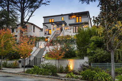 Inspiration for a large contemporary white three-story stucco exterior home remodel in San Francisco with a tile roof