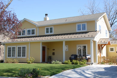 Example of a large transitional yellow two-story wood house exterior design in Baltimore with a hip roof and a shingle roof